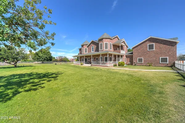 a front view of a house with a big yard