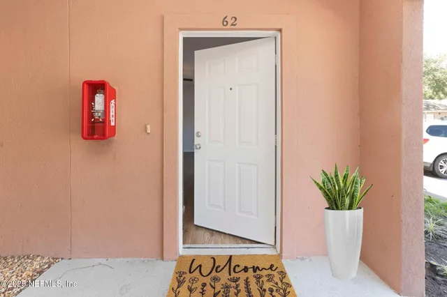 a view of room with window and flower pot