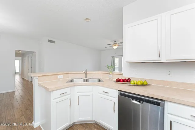 a view of a room with wooden floor and white walls