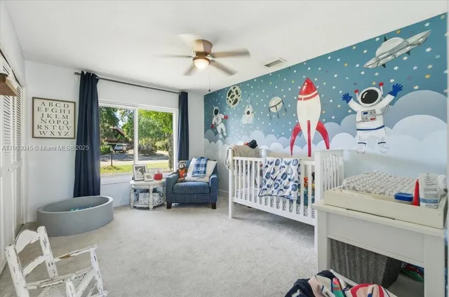 a living room with furniture and large windows