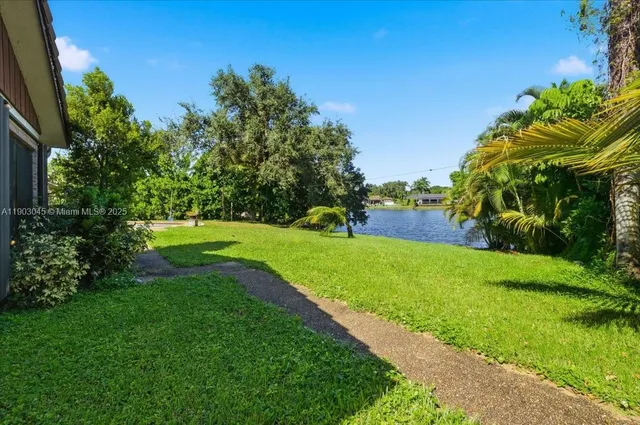 a view of a patio with table and chairs and couches with wooden floor