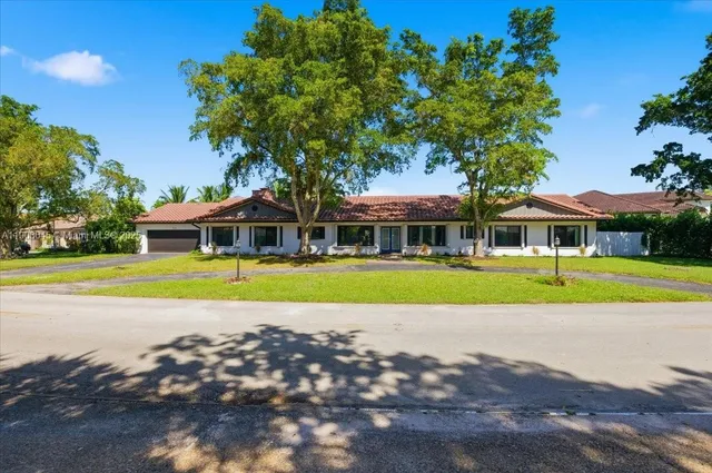 an aerial view of a house with a yard and garden