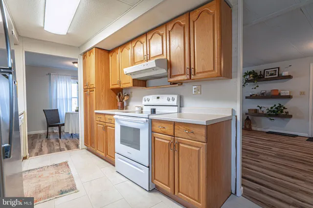 a kitchen with stainless steel appliances granite countertop a sink and a refrigerator