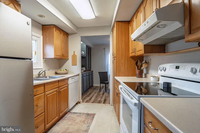 a kitchen with a sink stove and refrigerator