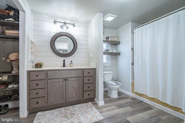a bathroom with a toilet a sink and a mirror
