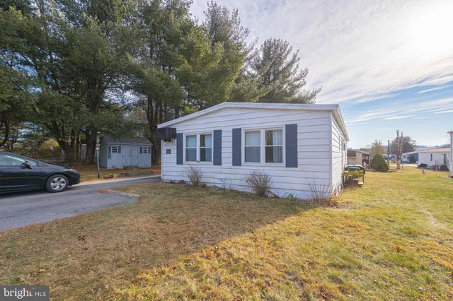 a view of a house with a yard and garage