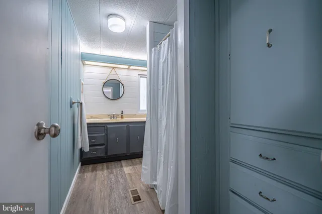 a bathroom with a granite countertop toilet sink and mirror