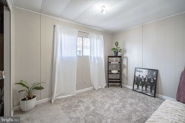 an empty room with closet and a window