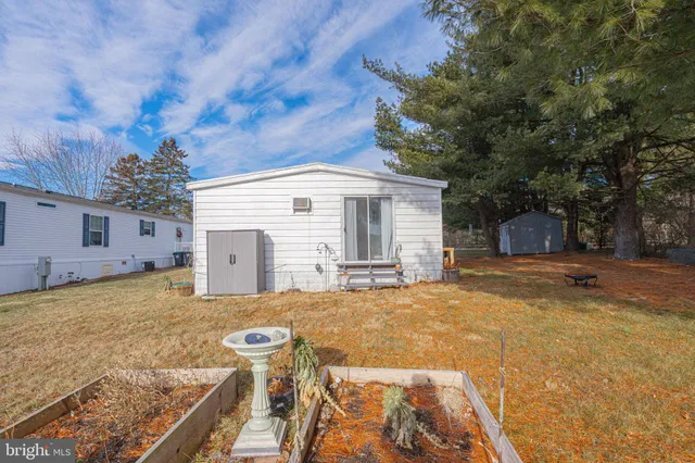 a view of a house with a yard covered in snow