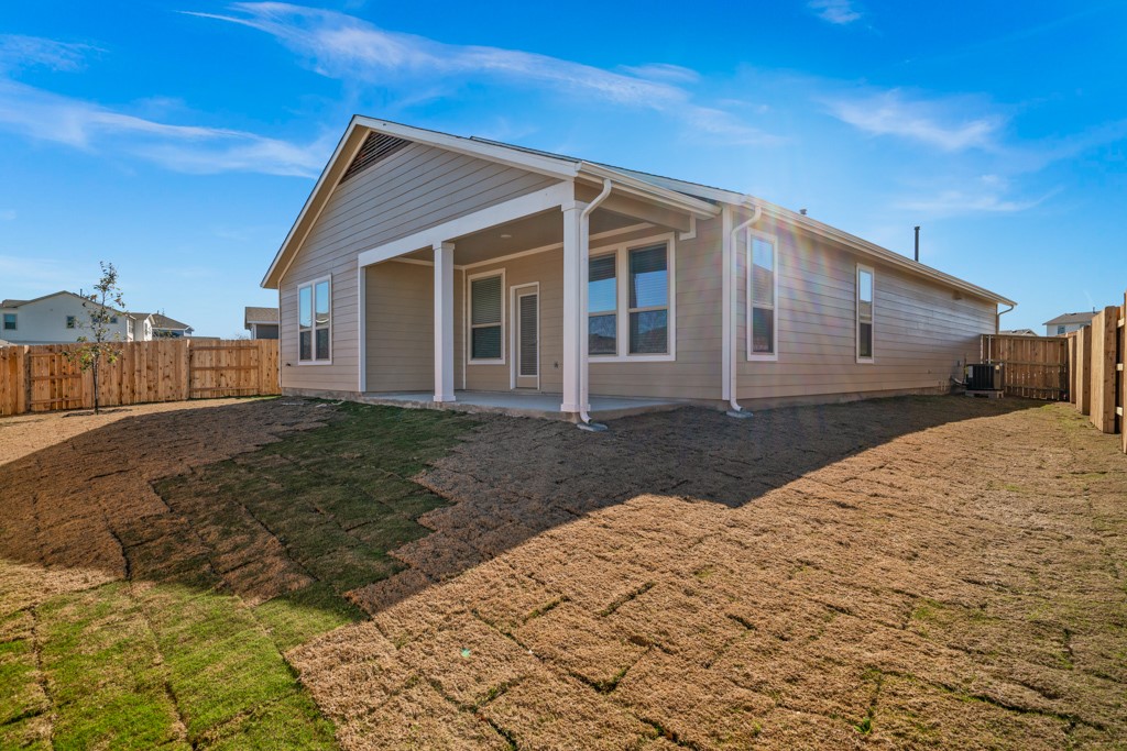8202 Dampton Lane Austin, TX 78744 - Photo 24 of 25 a front view of a house with a yard