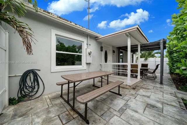 a view of a house with backyard and sitting area