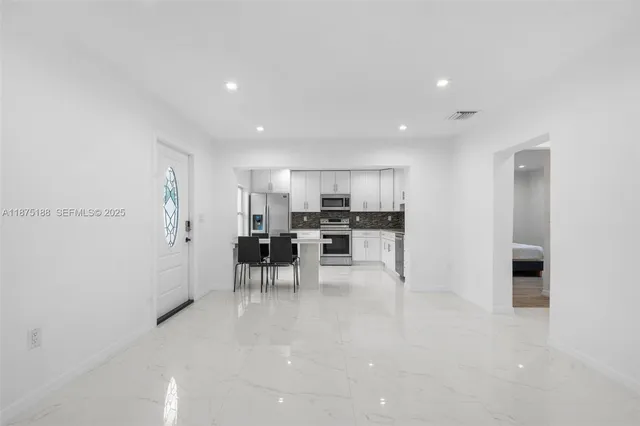 a view of dining room with furniture and a potted plant