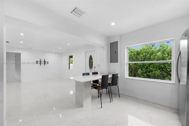 a view of a dining room with furniture window and outside view