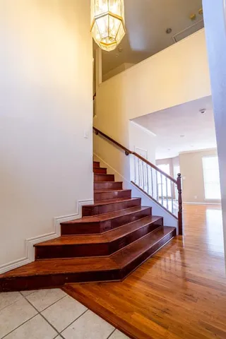 a view of entryway and hall with wooden floor