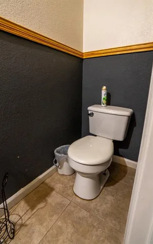 a white toilet sitting next to a shower curtain