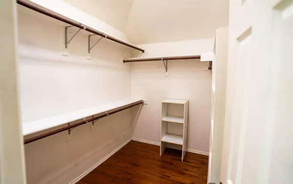 a bathroom with a double vanity sink toilet mirror and next to a window