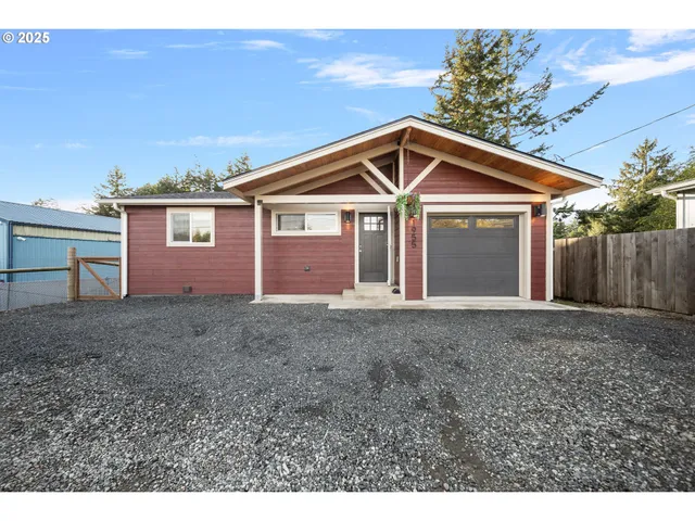 a view of a house with a yard and garage