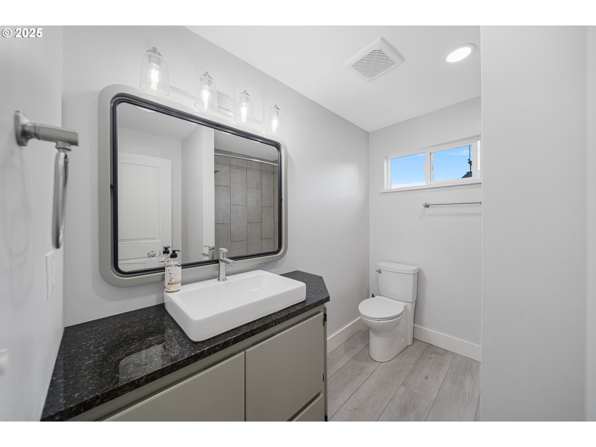 1955 28th Street Coos Bay, OR 97420 - Photo 21 of 48 a bathroom with a toilet sink and mirror