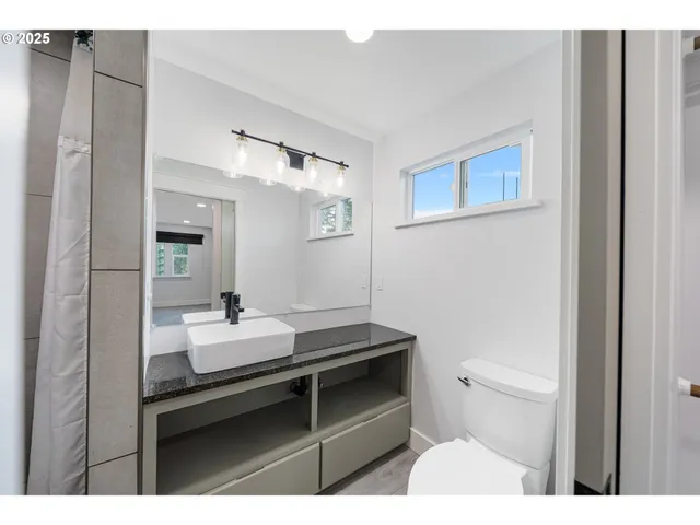 a bathroom with a sink toilet and mirror