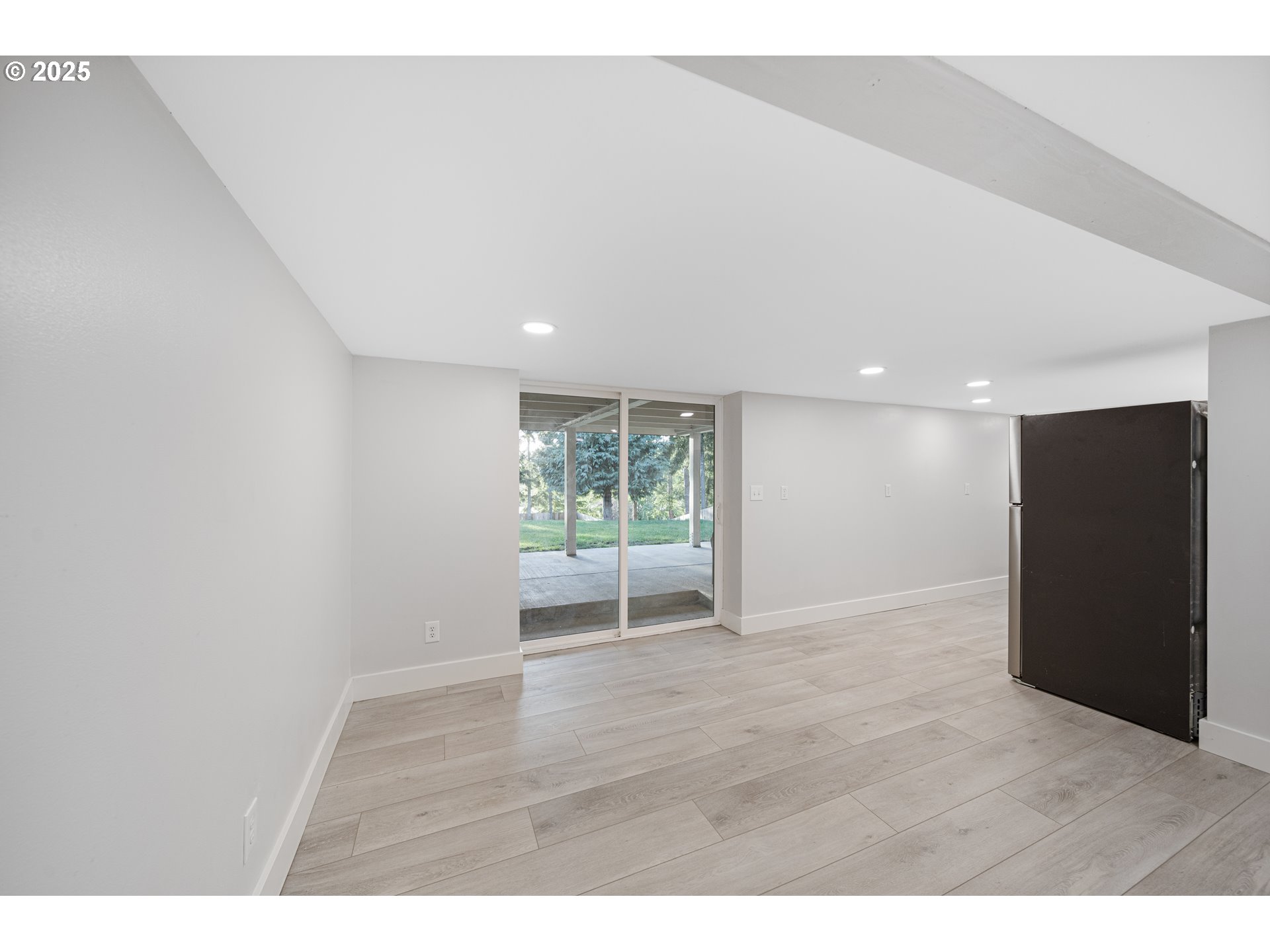 1955 28th Street Coos Bay, OR 97420 - Photo 36 of 48 a view of an empty room with wooden floor and a window