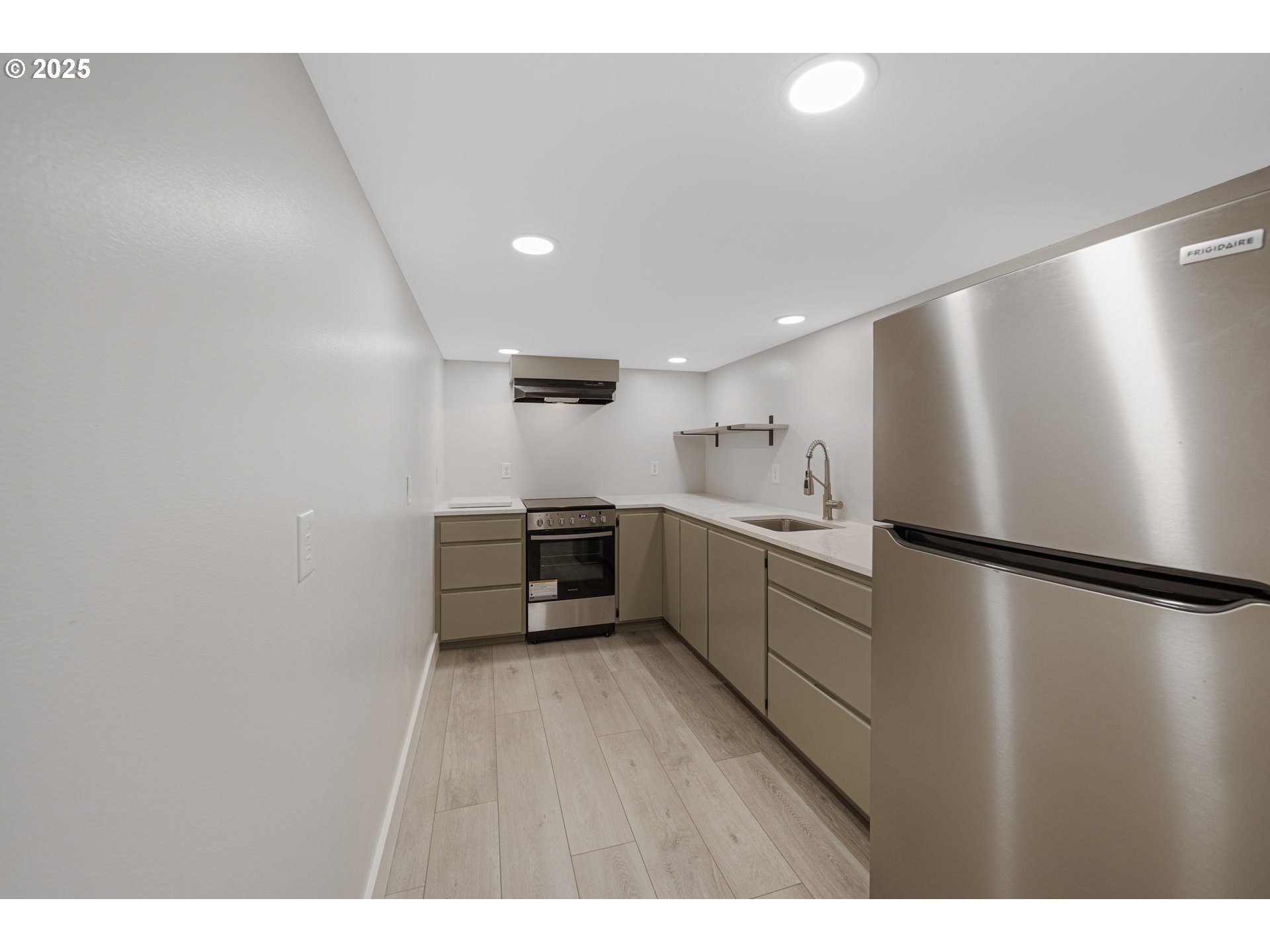 1955 28th Street Coos Bay, OR 97420 - Photo 37 of 48 a kitchen with a refrigerator a sink and cabinets
