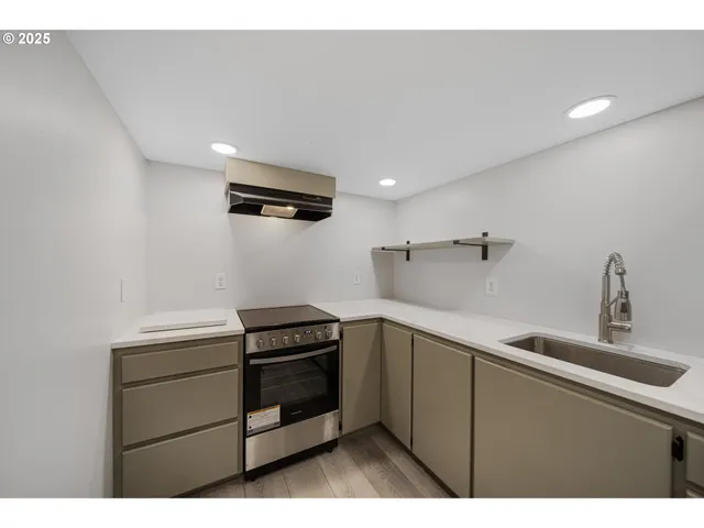 a kitchen that has a sink and cabinets