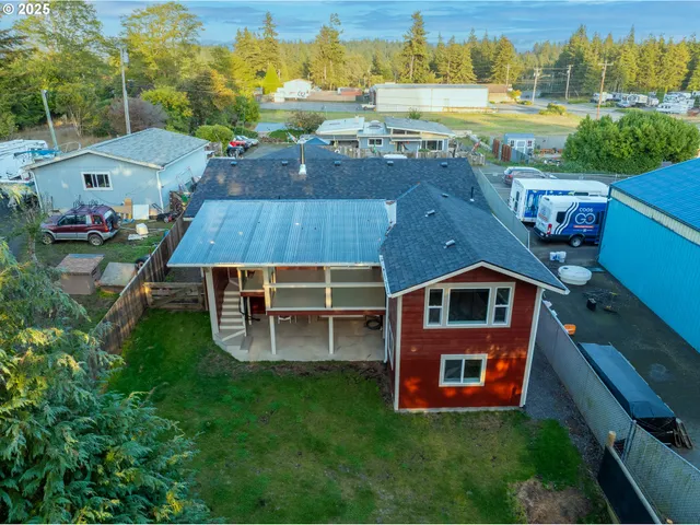 an aerial view of a house with a garden and lake view
