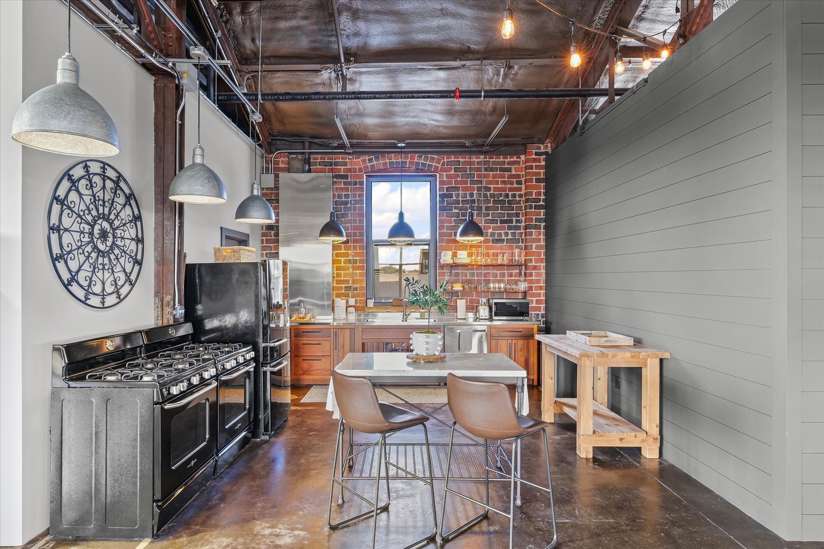 209 East Washington Street, Unit 5 Bloomington, IL 61701 - Photo 22 of 78 a kitchen with stainless steel appliances a stove a table and chairs