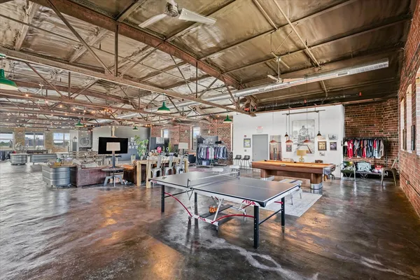 a room with pool table and tables