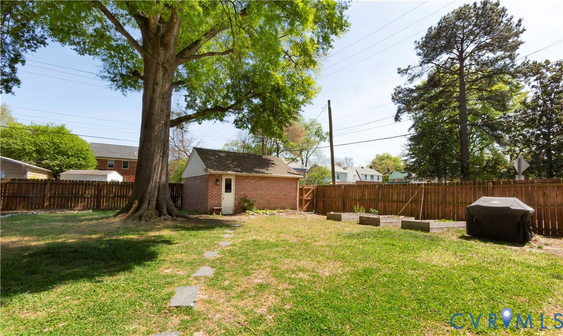 4801 Brook Road Richmond, VA 23227 - Photo 23 of 28 a view of a backyard with a small cabin and a chair