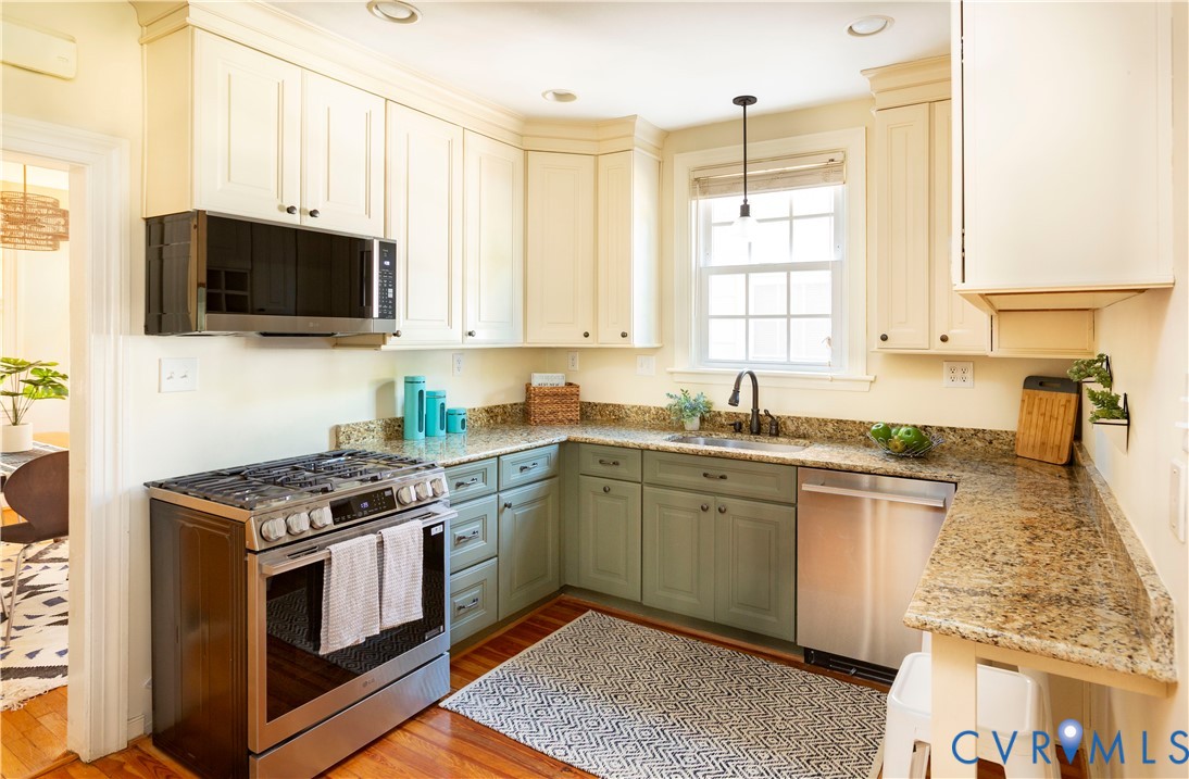 4801 Brook Road Richmond, VA 23227 - Photo 10 of 28 a kitchen with stainless steel appliances granite countertop a stove a sink and a microwave