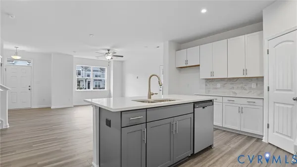 a kitchen with a sink cabinets and wooden floor