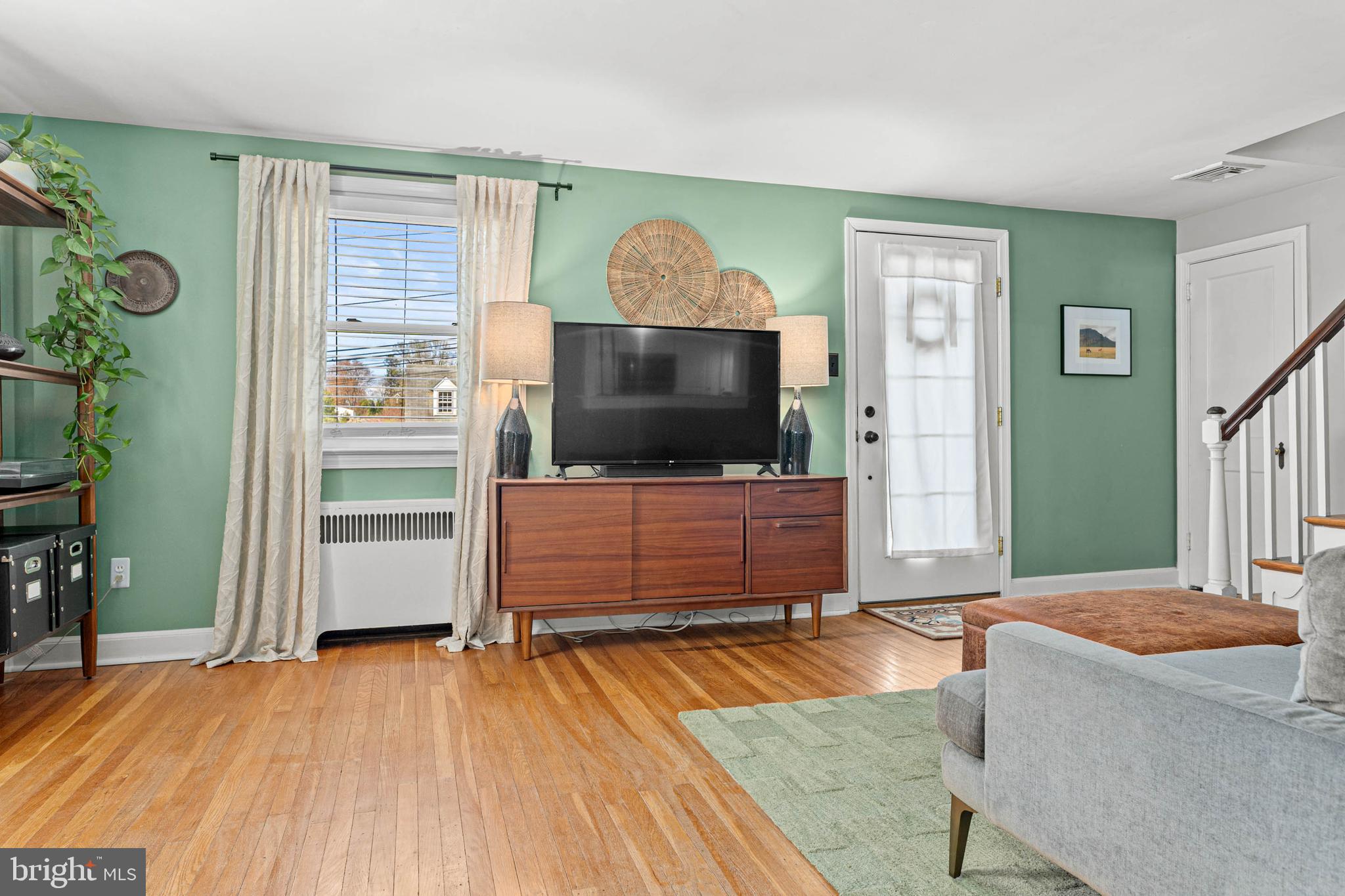 21 Moreland Road Paoli, PA 19301 - Photo 4 of 29 a living room with a flat screen tv and a wooden floor