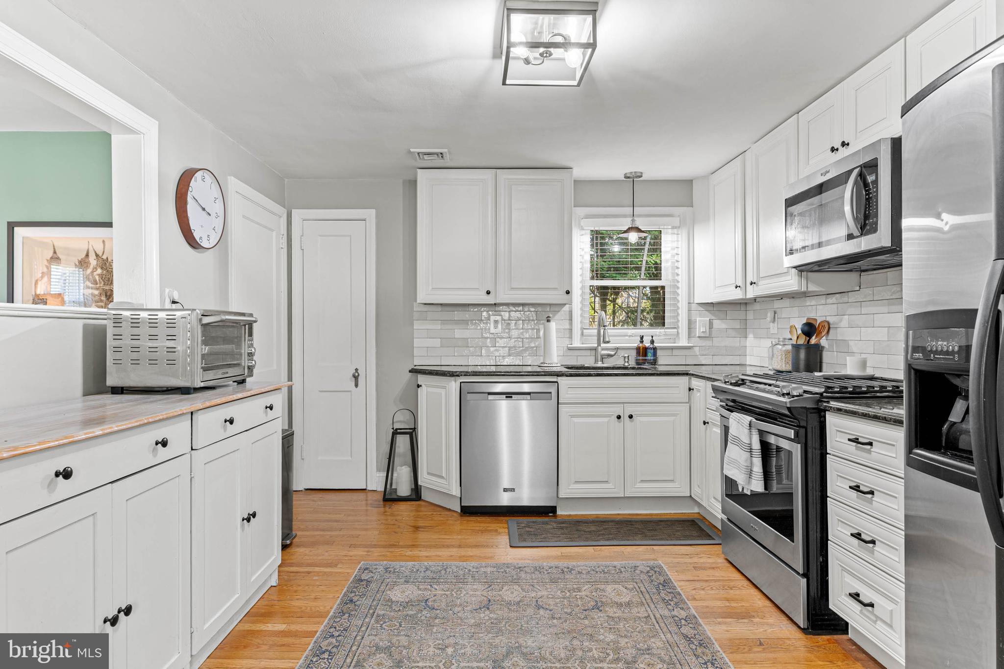 21 Moreland Road Paoli, PA 19301 - Photo 6 of 29 a kitchen with stainless steel appliances granite countertop a stove a sink and a granite counter tops