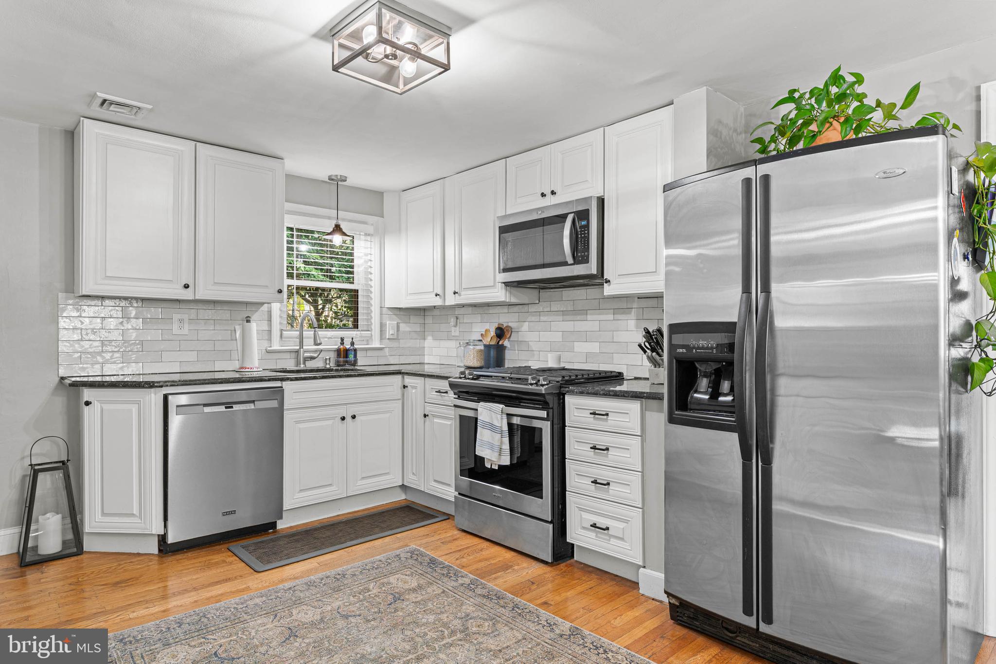 21 Moreland Road Paoli, PA 19301 - Photo 8 of 29 a kitchen with cabinets stainless steel appliances and a window