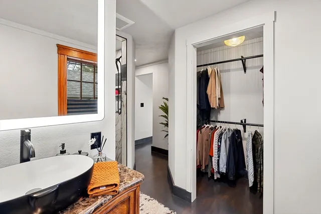 a view of walk in closet with clothes and shoes