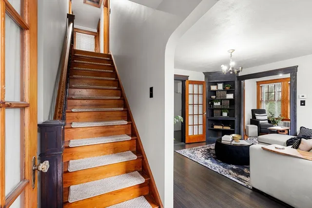 a view of entryway and hall with wooden floor
