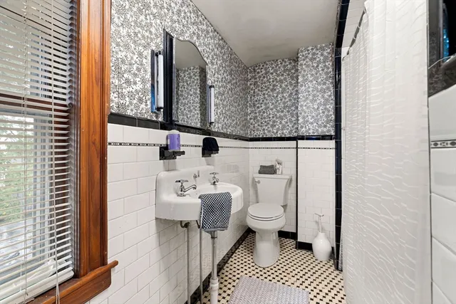 a bathroom with a sink toilet and mirror