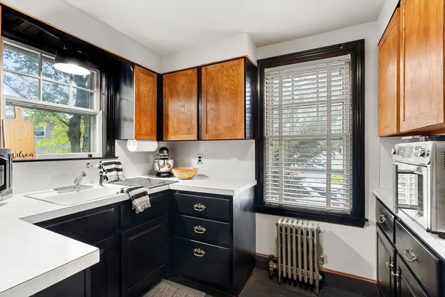 a kitchen with a sink a window and cabinets