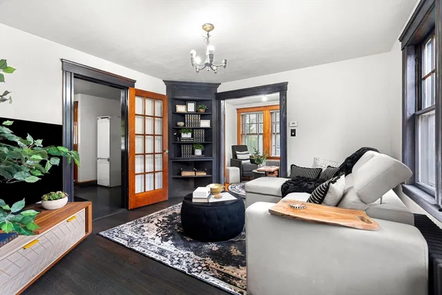 a living room with furniture and a chandelier