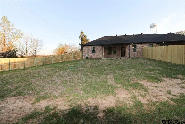 a view of a house with backyard and lake view