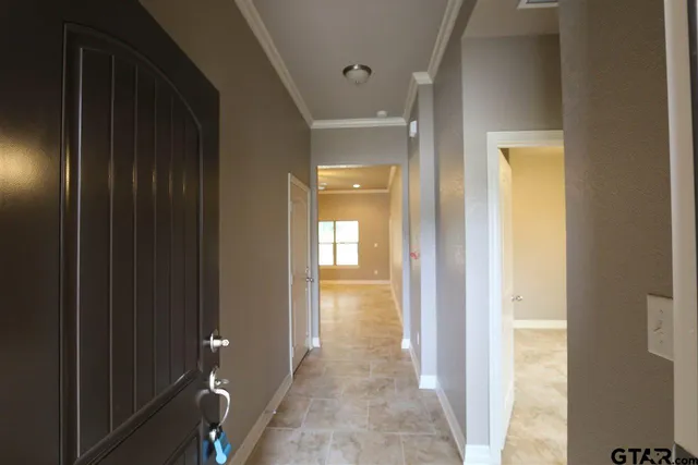 a view of a hallway with wooden shelves