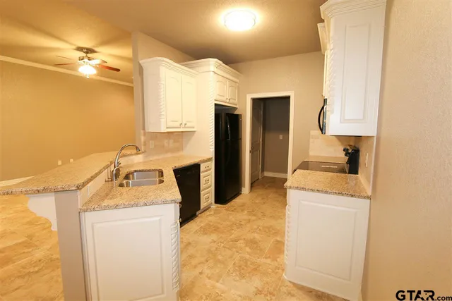 a bathroom with a granite countertop sink a vanity and a mirror