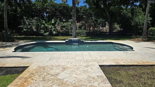 a view of swimming pool with a yard