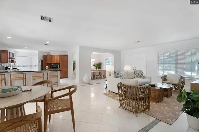 a living room with lots of furniture and kitchen view