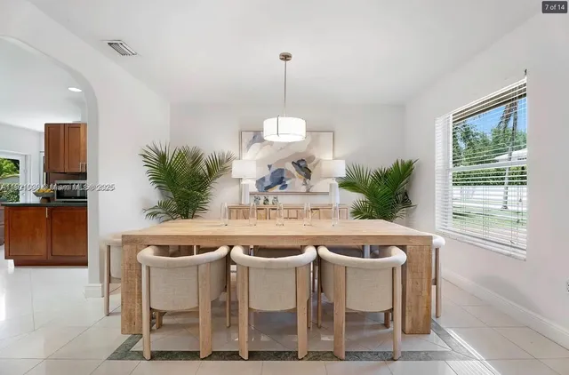 a dining room with furniture a window and a chandelier
