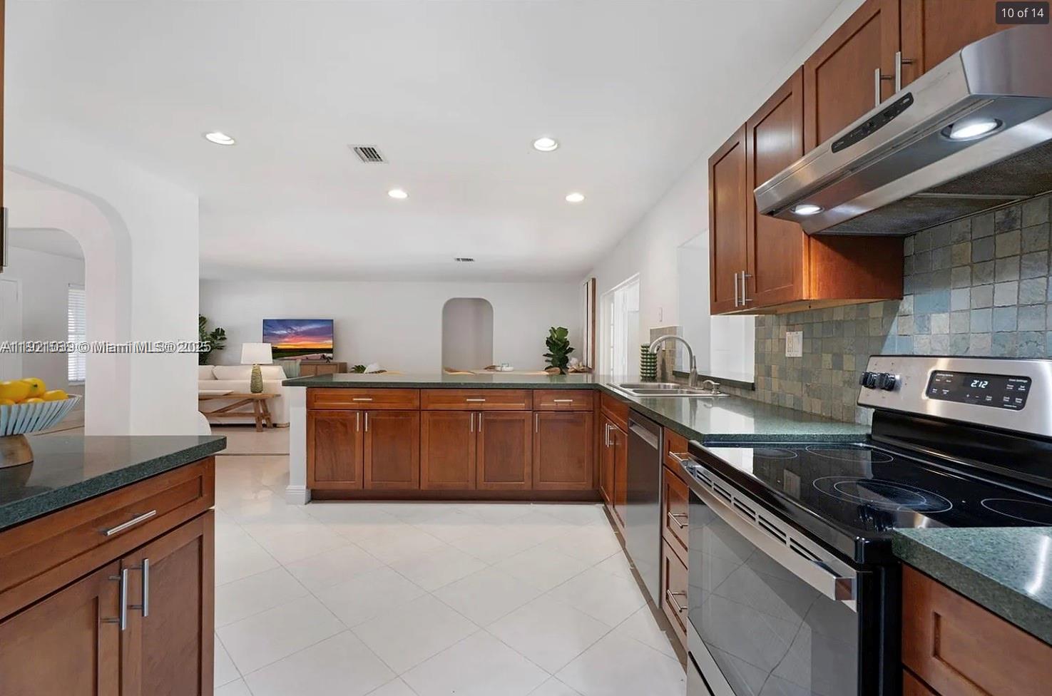 8700 Southwest 64th Avenue Pinecrest, FL 33156 - Photo 10 of 14 a kitchen with a stove and a refrigerator