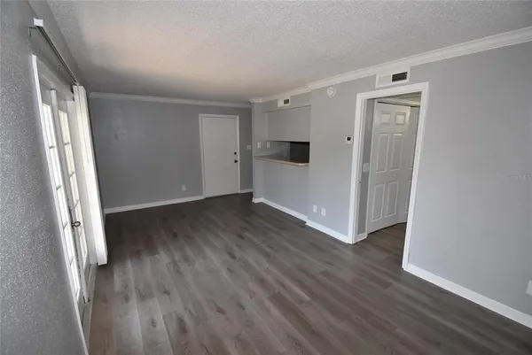 an empty room with wooden floor and a window