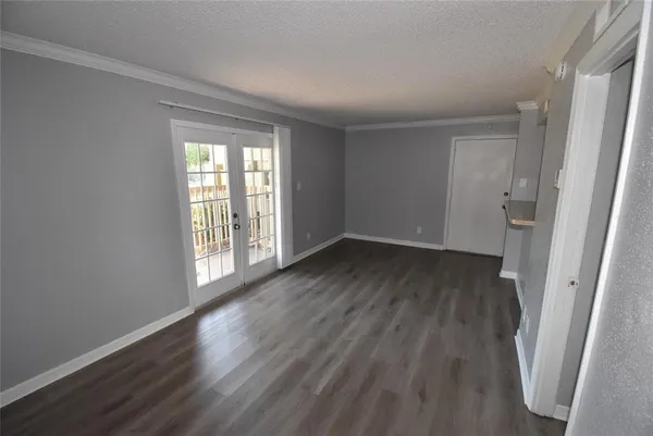 a view of wooden floor and windows in a room