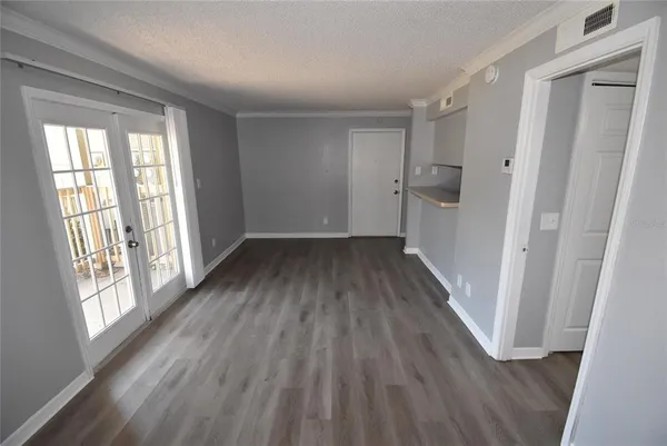 a view of hallway with a large window and wooden floor